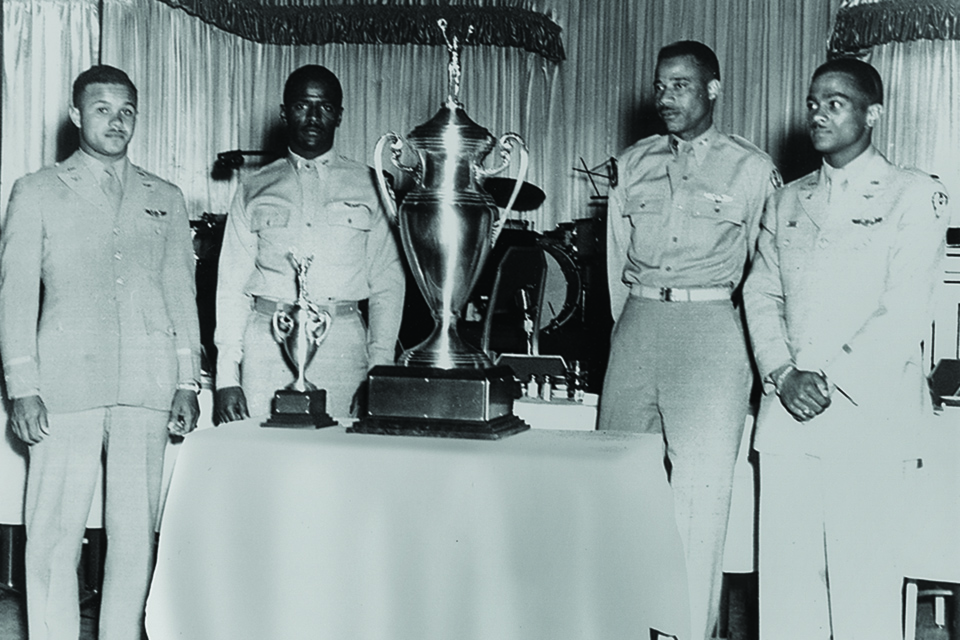The four winning Tuskegee Airmen—(from left) Alexander, Harvey, Temple and Stewart—pose with their “Top Gun” trophy in 1949. (tuskegeetopgun.com)