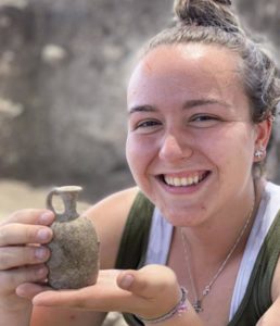 Student holding a jug, the future of archaeology